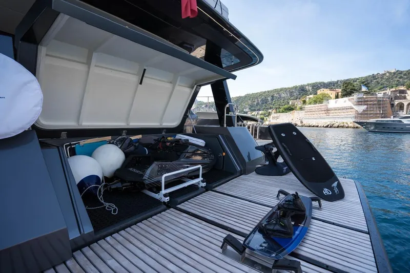 Double Happiness Yacht Photos Pics 2024 Sunreef 60 Sunreef Power Eco yacht with open storage, water sports gear, docked by scenic coastline.