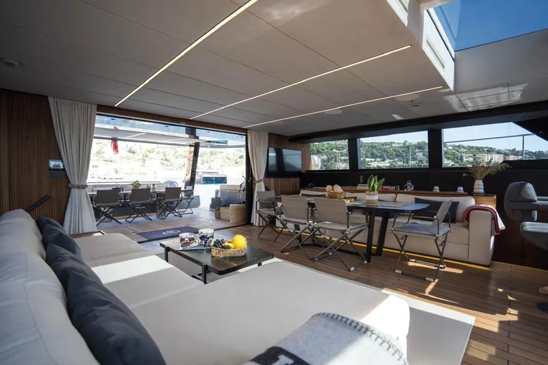 Double Happiness Yacht Photos Pics Luxurious interior of 2024 Sunreef 60 Sunreef Power Eco yacht with elegant seating and dining area.