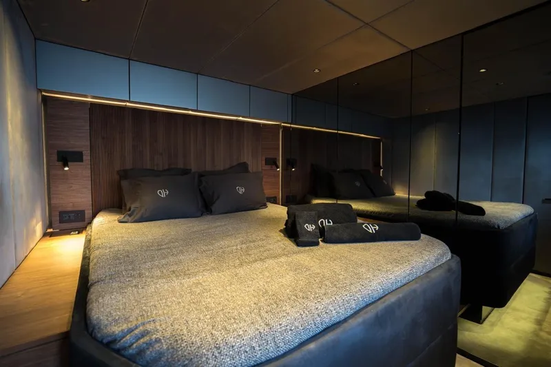 Double Happiness Yacht Photos Pics Luxurious bedroom interior of 2024 Sunreef 60 Sunreef Power Eco yacht, featuring elegant bedding.