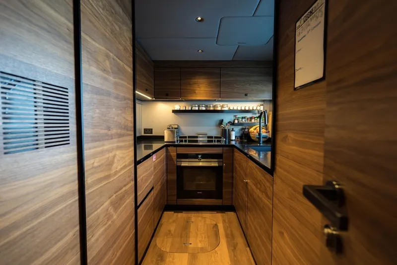 Double Happiness Yacht Photos Pics Luxurious wooden kitchen interior of 2024 Sunreef 60 Sunreef Power Eco yacht.