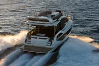 2025 Galeon 480 Fly yacht cruising on open water at sunset.