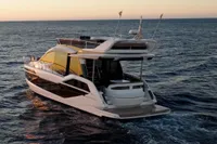 2025 Galeon 480 Fly yacht cruising at sunset on open sea.