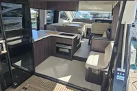 Interior of 2025 Galeon 480 Fly yacht with modern seating and kitchen area.