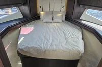 Luxurious bedroom interior of 2025 Galeon 480 Fly yacht with elegant bedding.