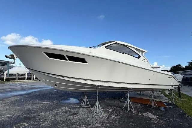  Yacht Photos Pics 2025 Pursuit DC 365 Dual Console boat on display, elevated on stands.