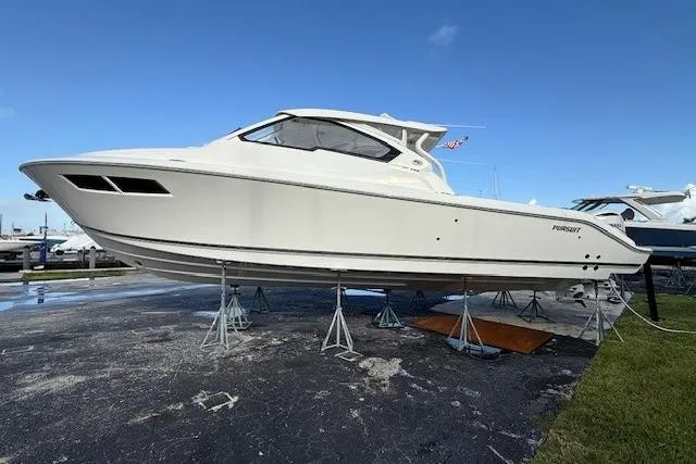  Yacht Photos Pics 2025 Pursuit DC 365 Dual Console boat on stands, side view.
