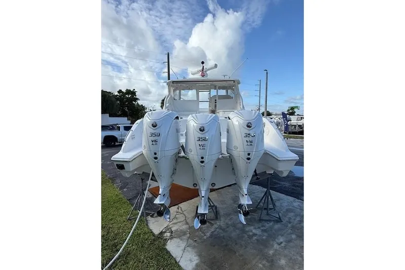  Yacht Photos Pics 2025 Pursuit DC 365 Dual Console boat with triple 350 V6 engines, docked outdoors.