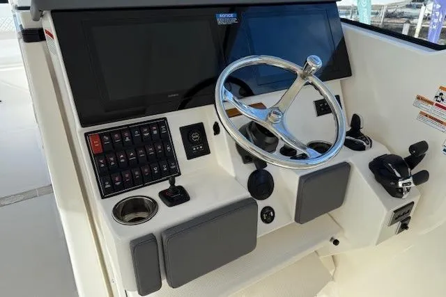  Yacht Photos Pics 2025 Pursuit DC 365 Dual Console boat dashboard with steering wheel and control panel.