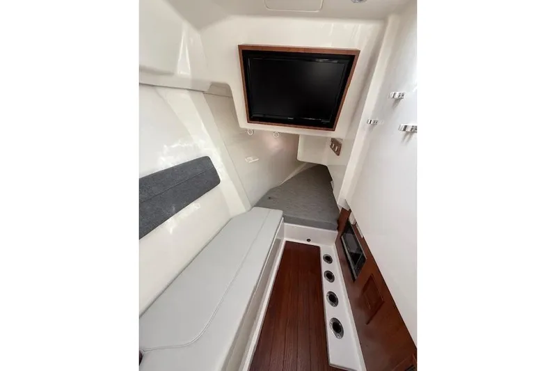  Yacht Photos Pics Interior of 2025 Pursuit DC 365 Dual Console boat with seating and TV.