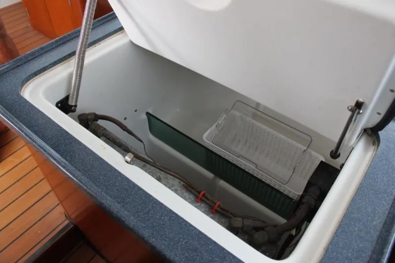 Mangata Yacht Photos Pics Open storage compartment on 2003 Lagoon 43 PC boat with visible wiring and components.