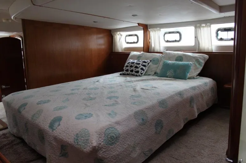 Mangata Yacht Photos Pics Cozy bedroom in 2003 Lagoon 43 PC yacht with nautical-themed bedding.