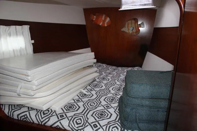 Mangata Yacht Photos Pics Cabin interior of 2003 Lagoon 43 PC with geometric bedding and stacked cushions.