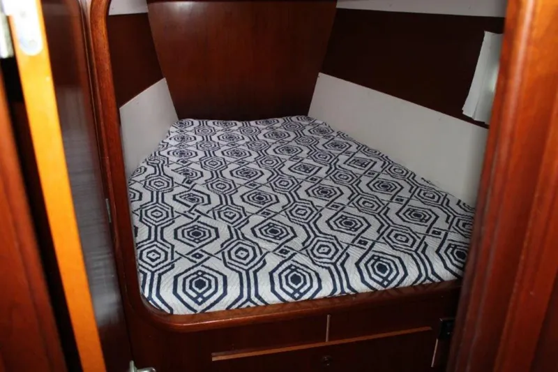 Mangata Yacht Photos Pics Cabin interior of 2003 Lagoon 43 PC with geometric-patterned bedspread.