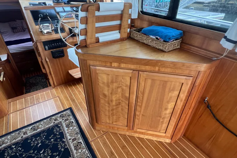 Semper Fi Yacht Photos Pics Interior of 2004 Sabre 36 Hardtop Sedan with wooden cabinetry and helm station.