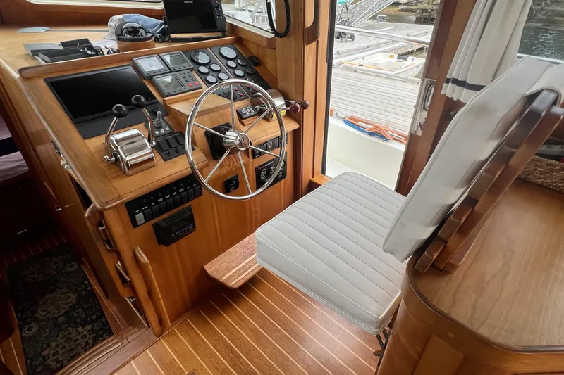 Semper Fi Yacht Photos Pics 2004 Sabre 36 Hardtop Sedan helm with wooden dashboard and steering wheel.