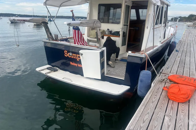 Semper Fi Yacht Photos Pics 2004 Sabre 36 Hardtop Sedan docked, featuring American flag and nautical equipment.