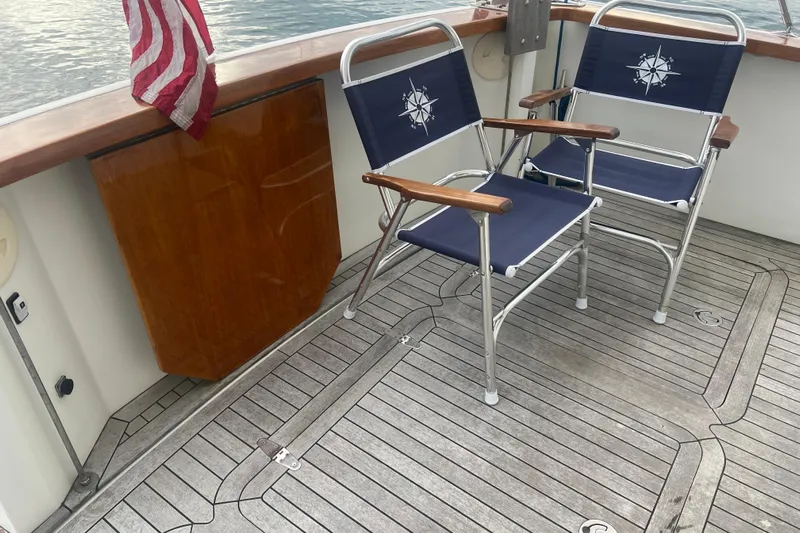 Semper Fi Yacht Photos Pics 2004 Sabre 36 Hardtop Sedan deck with chairs and American flag.