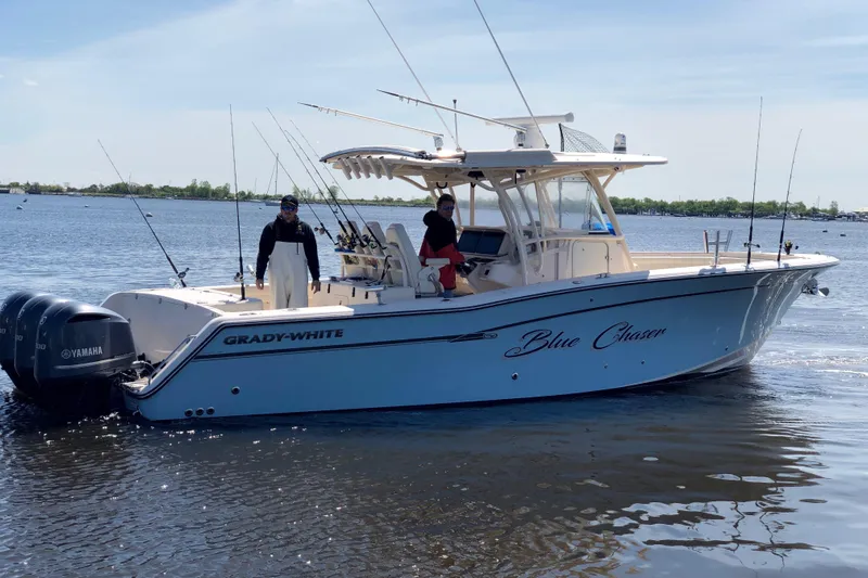  Yacht Photos Pics 2016 Grady-White Canyon 336 boat named "Blue Chaser" on water with two people aboard.