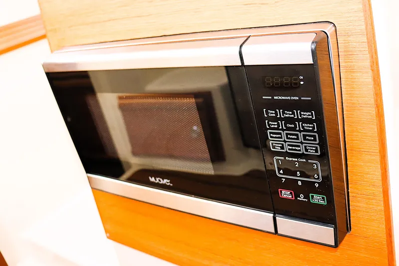 Tail Finn Yacht Photos Pics Microwave oven in 2021 Ranger Tugs R-27 boat interior, featuring digital controls.