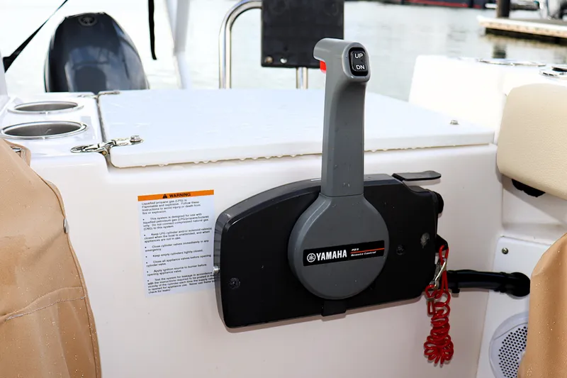 Tail Finn Yacht Photos Pics Yamaha throttle control on 2021 Ranger Tugs R-27 boat, featuring cup holders and safety warning label.