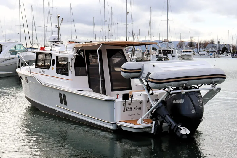 Tail Finn Yacht Photos Pics 2021 Ranger Tugs R-27 boat docked, featuring Yamaha outboard motor and inflatable dinghy.