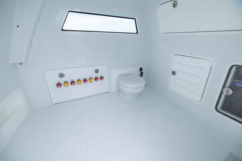  Yacht Photos Pics Interior of 2026 Invincible 40 Catamaran featuring a modern marine toilet and control panel.