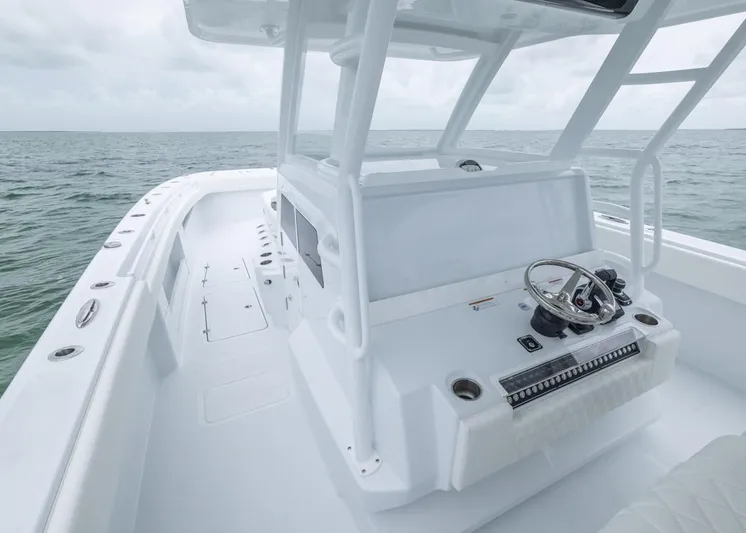  Yacht Photos Pics 2026 Invincible 40 Catamaran, sleek white design, open sea view, modern helm station.