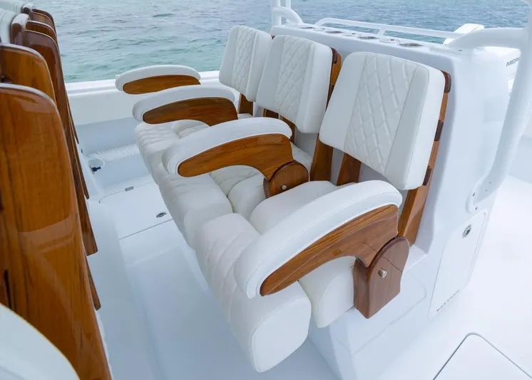  Yacht Photos Pics Luxurious seating on 2026 Invincible 40 Catamaran with white cushions and wooden accents.