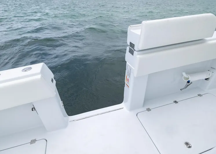  Yacht Photos Pics 2026 Invincible 40 Catamaran deck with ocean view, featuring white seating and storage.