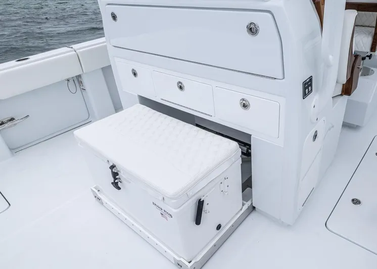  Yacht Photos Pics Invincible 40 Catamaran 2026 interior with storage drawers and cushioned cooler seat.