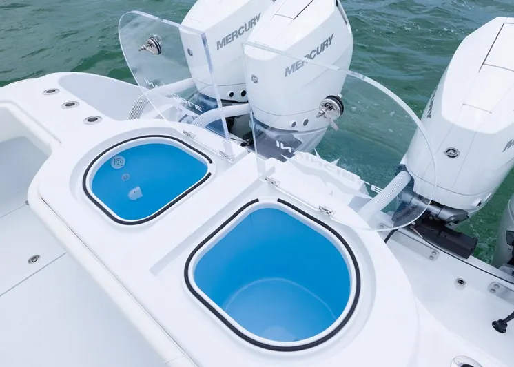  Yacht Photos Pics 2026 Invincible 40 Catamaran with dual Mercury engines and blue livewells on deck.