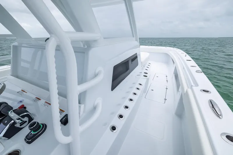  Yacht Photos Pics 2026 Invincible 40 Catamaran deck with modern controls, cruising on open water.