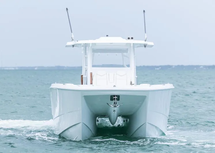  Yacht Photos Pics 2026 Invincible 40 Catamaran cruising on open water, front view.