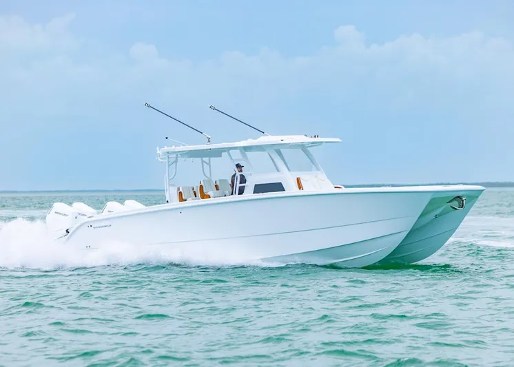  Yacht Photos Pics 2026 Invincible 40 Catamaran cruising on open water, showcasing sleek design and powerful engines.