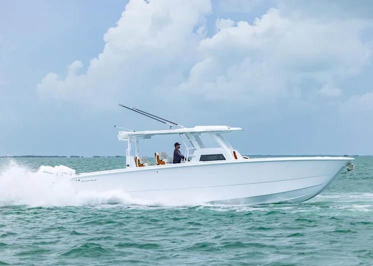  Yacht Photos Pics 2026 Invincible 40 Catamaran cruising on open water under a cloudy sky.