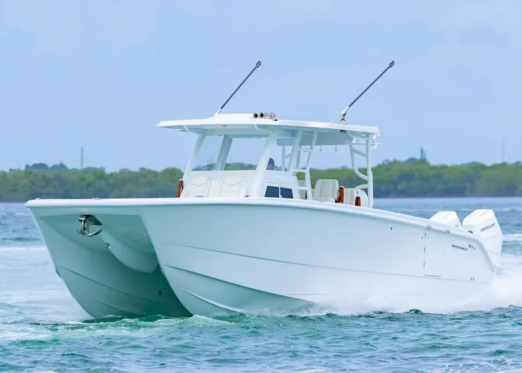  Yacht Photos Pics 2026 Invincible 40 Catamaran cruising on water, showcasing sleek design and powerful engines.