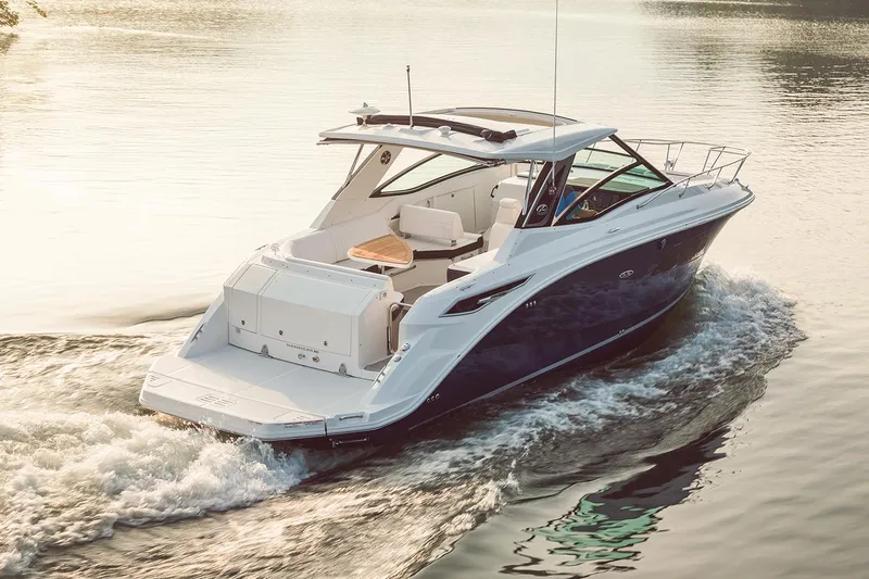  Yacht Photos Pics Manufacturer Provided Image: 2025 Sea Ray Sundancer 320 cruising on calm water at sunset.