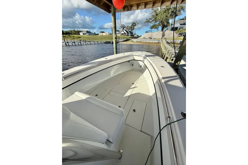  Yacht Photos Pics 2023 Contender 30 Tournament boat docked, showcasing spacious deck and sleek design.