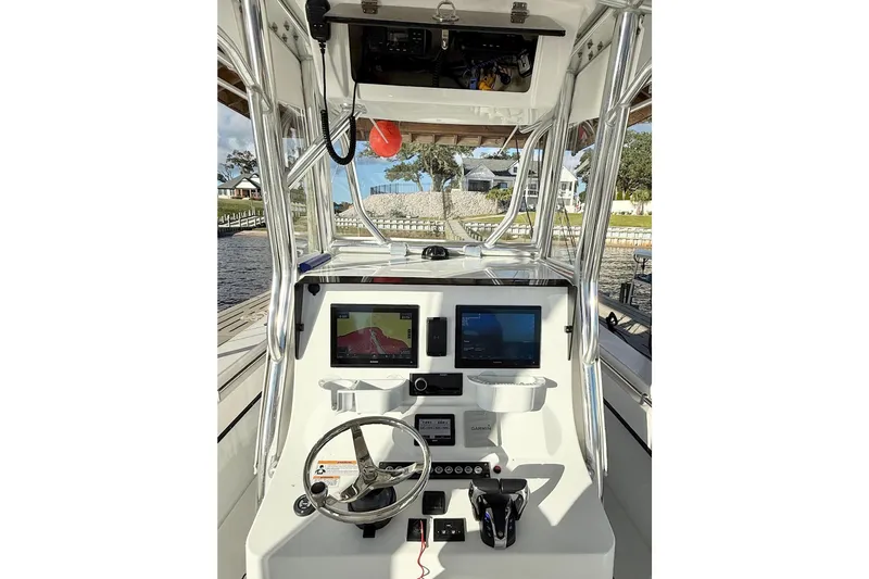 Yacht Photos Pics 2023 Contender 30 Tournament boat dashboard with modern navigation equipment and steering wheel.