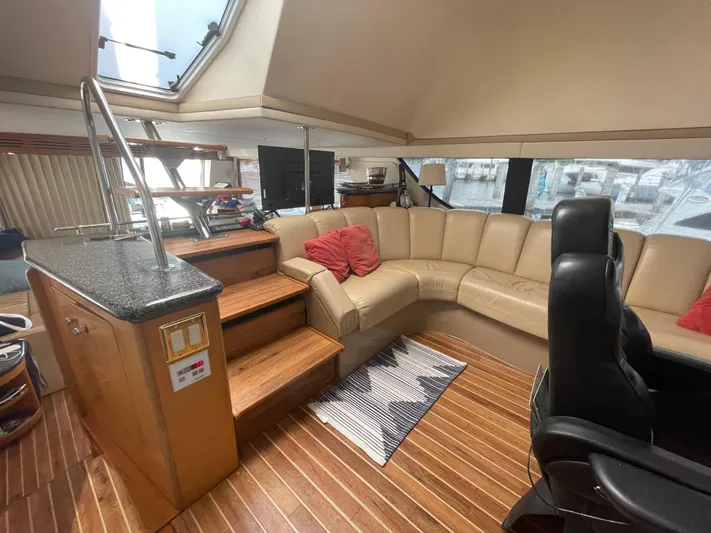  Yacht Photos Pics Luxurious interior of 2000 Carver 530 Voyager Pilothouse with leather seating and wooden flooring.