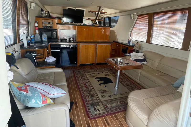  Yacht Photos Pics Interior of 2000 Carver 530 Voyager Pilothouse with leather seating and wooden cabinetry.