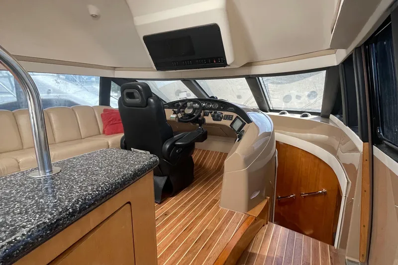  Yacht Photos Pics Interior of 2000 Carver 530 Voyager Pilothouse with helm, seating, and wood flooring.
