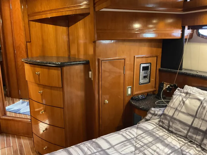  Yacht Photos Pics Interior of 2000 Carver 530 Voyager Pilothouse with wood cabinetry and plaid bedding.