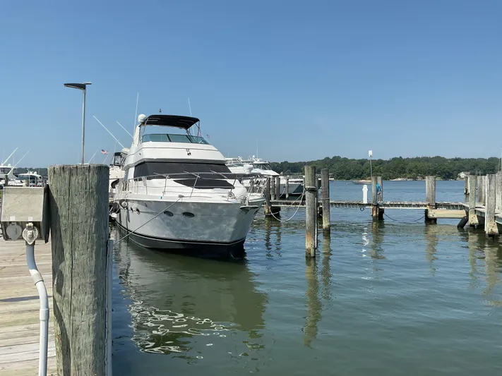  Yacht Photos Pics 2000 Carver 530 Voyager Pilothouse yacht docked at marina under clear blue sky.