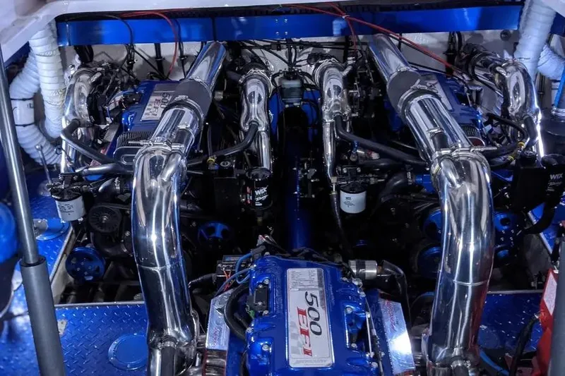  Yacht Photos Pics Engine compartment of a 2000 Donzi Daytona 45 with chrome and blue components.