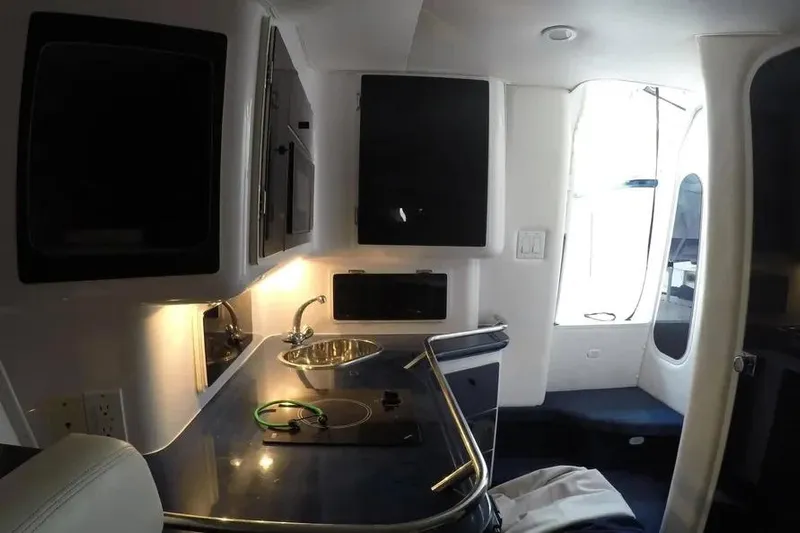  Yacht Photos Pics Interior of 2000 Donzi Daytona 45 boat featuring a compact kitchen area.