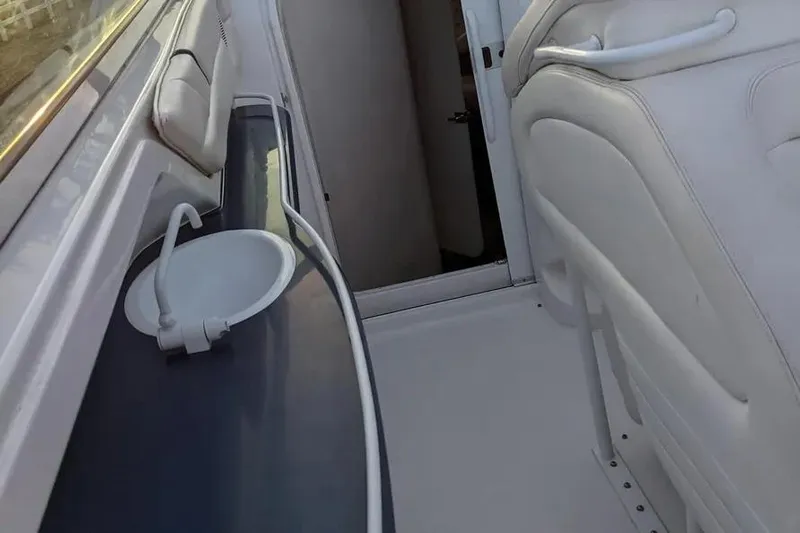  Yacht Photos Pics Interior of 2000 Donzi Daytona 45 boat with sink and seating area.