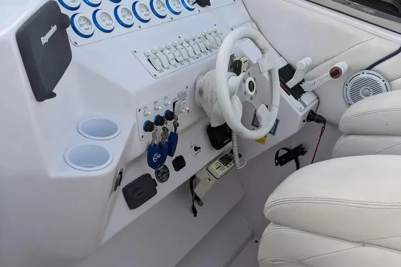  Yacht Photos Pics Control panel of a 2000 Donzi Daytona 45 boat with steering wheel and gauges.