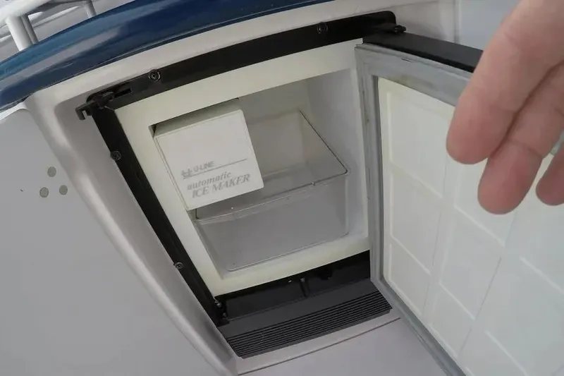  Yacht Photos Pics Open ice maker on 2000 Donzi Daytona 45 boat, showing interior compartment.