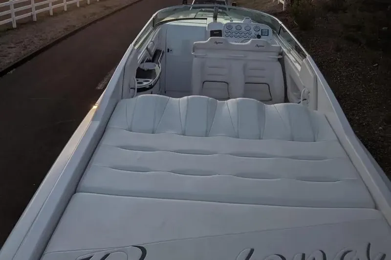  Yacht Photos Pics 2000 Donzi Daytona 45 boat interior with white seating and dashboard, parked on a road.